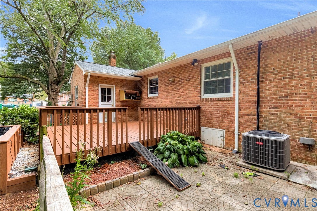 5215 Sprucewood Avenue, North Chesterfield, VA 23234 Expansive brick exterior with a wood-stained deck and an exterior door
