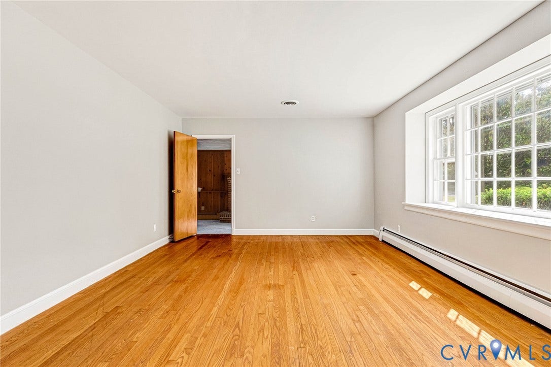 5215 Sprucewood Avenue, North Chesterfield, VA 23234 Hardwood flooring, light gray wall finishes, white trim, and a multi-pane window