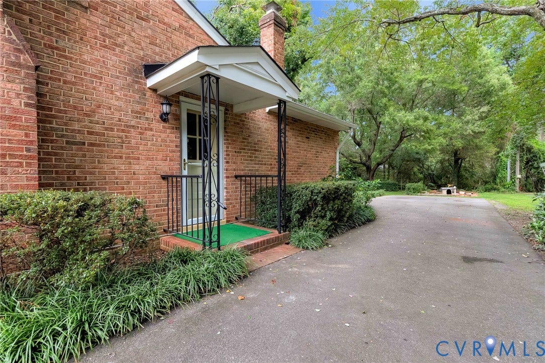 5215 Sprucewood Avenue, North Chesterfield, VA 23234 Brick exterior featuring a covered entry with decorative wrought iron supports and handrails