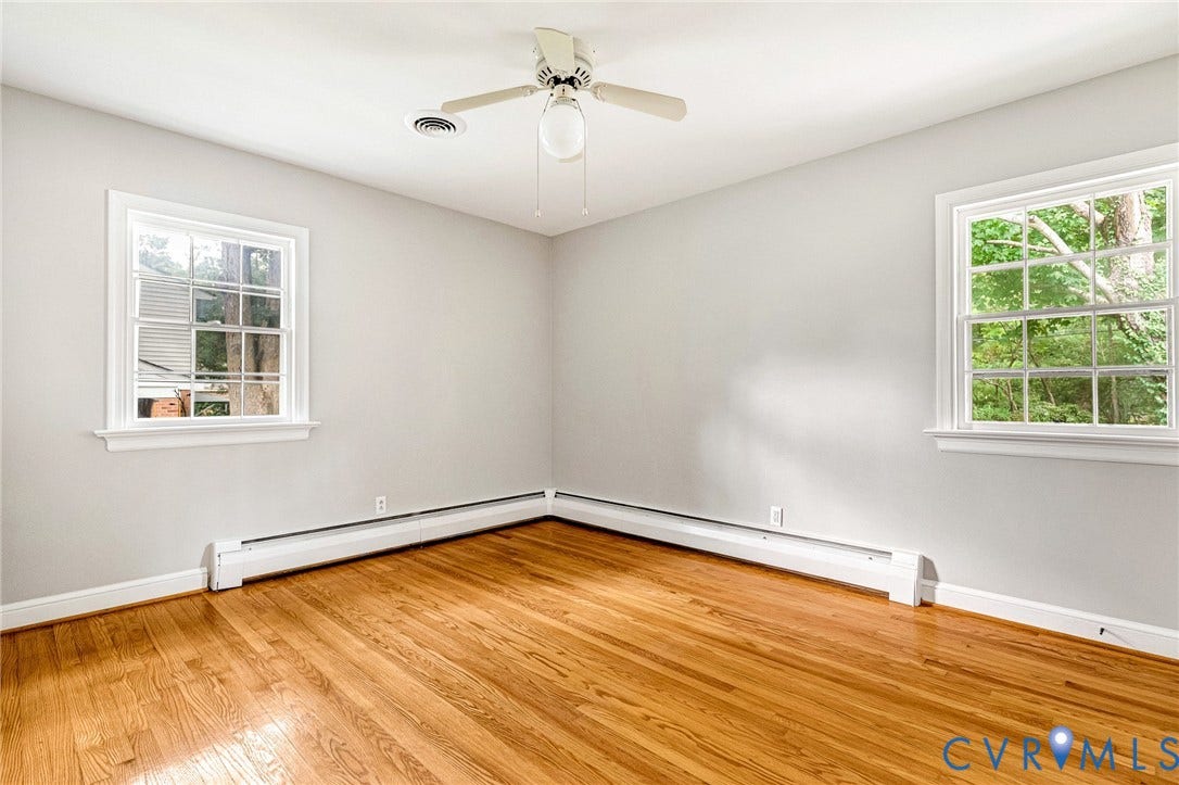 5215 Sprucewood Avenue, North Chesterfield, VA 23234 Hardwood flooring, two large windows, white walls, ceiling fan with integrated lighting, and white trim