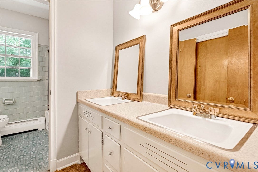5215 Sprucewood Avenue, North Chesterfield, VA 23234 Dual vanity with integrated sinks, wood-finish framed mirrors, and white cabinetry
