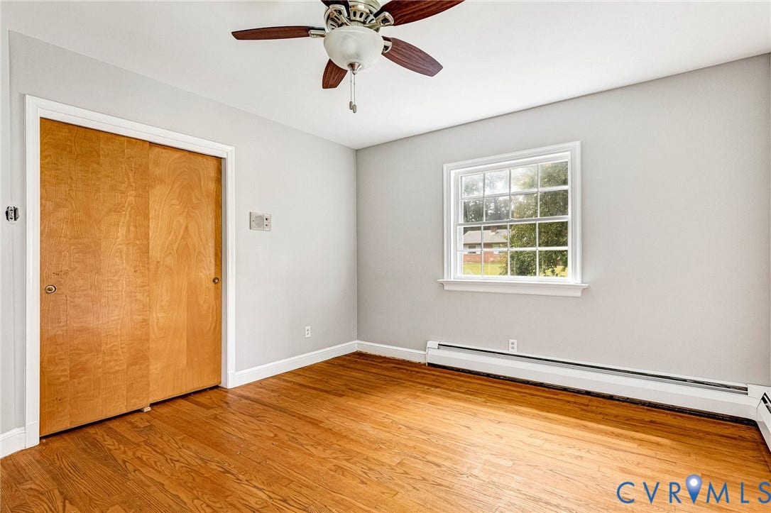 5215 Sprucewood Avenue, North Chesterfield, VA 23234 Hardwood flooring, light gray walls, white trim, window with grids, and a ceiling fan with light fixture