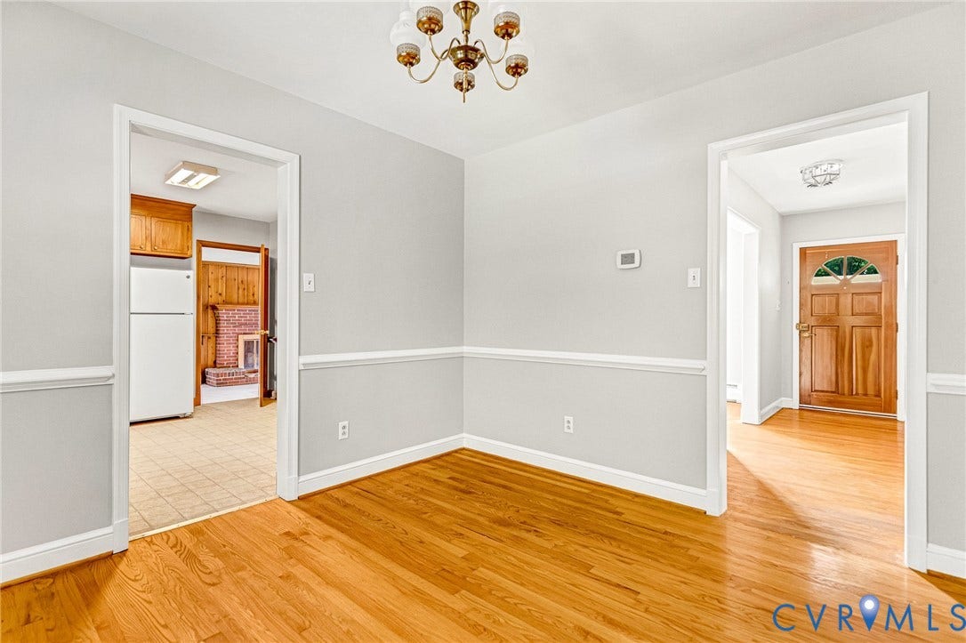 5215 Sprucewood Avenue, North Chesterfield, VA 23234 Hardwood flooring, painted walls with chair rail trim, and a brass chandelier