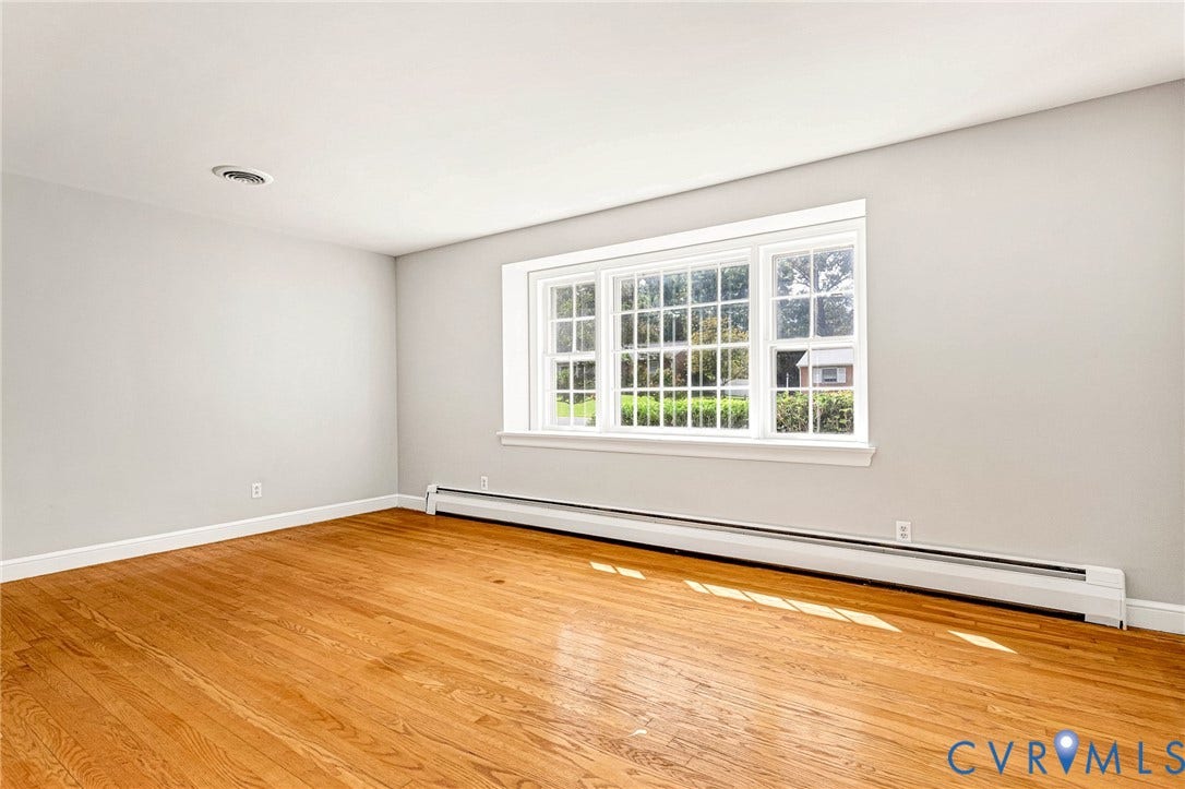 5215 Sprucewood Avenue, North Chesterfield, VA 23234 Hardwood flooring, light gray wall finish, white trim, and a window with muntins