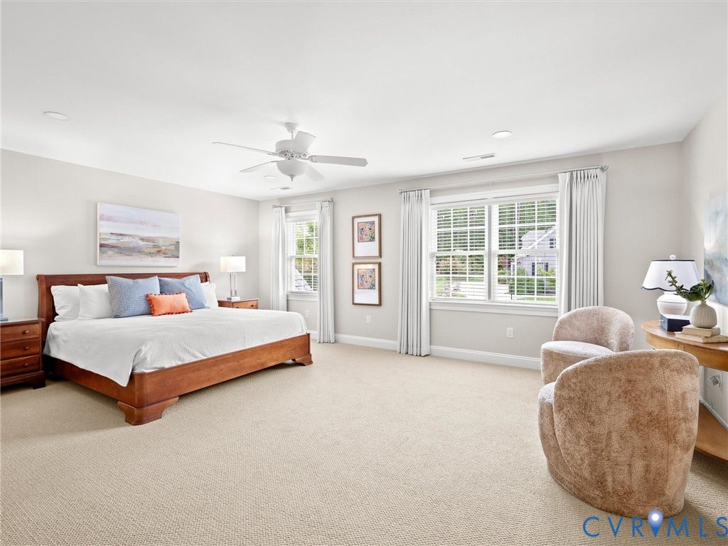 Neutral carpeting throughout with recessed lighting and a ceiling fan