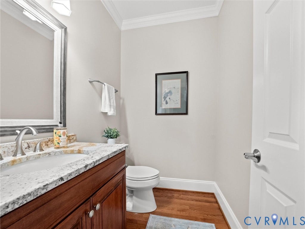 Vanity with a granite countertop, undermount sink, and brushed nickel faucet