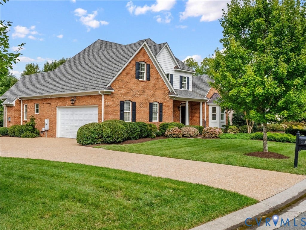 Brick exterior with white window trim and black shutters