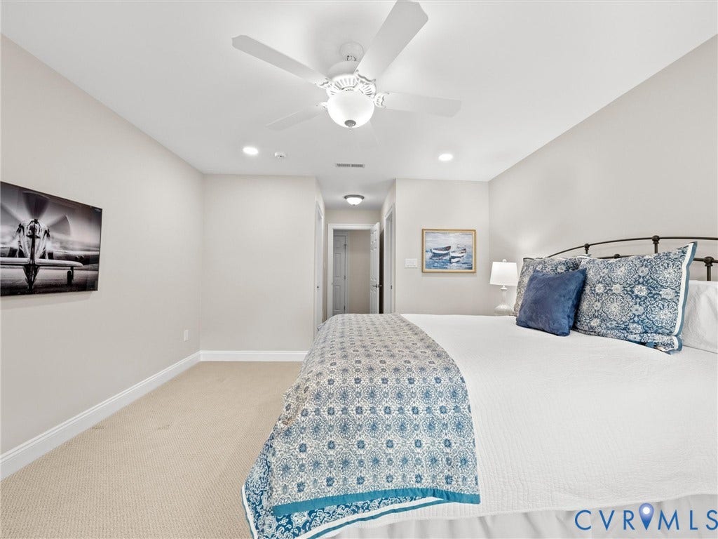 Recessed lighting, ceiling fan, neutral wall paint, and carpeted flooring