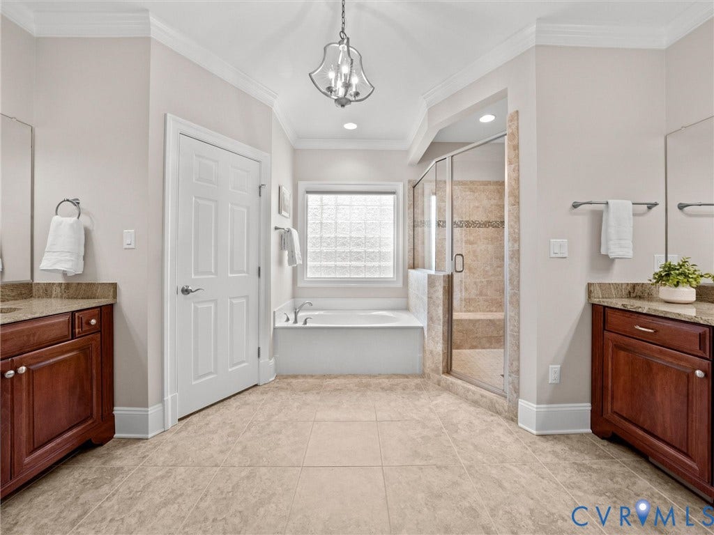 Dual vanity sinks with wood-finish cabinetry and stone countertops
