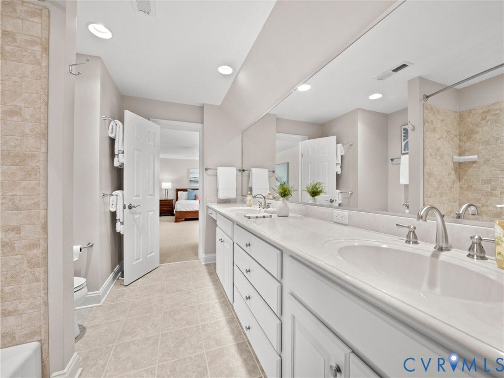 Dual vanity with white cabinetry and integrated sinks