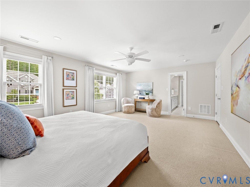 Spacious room featuring neutral carpet flooring, recessed lighting, and a ceiling fan