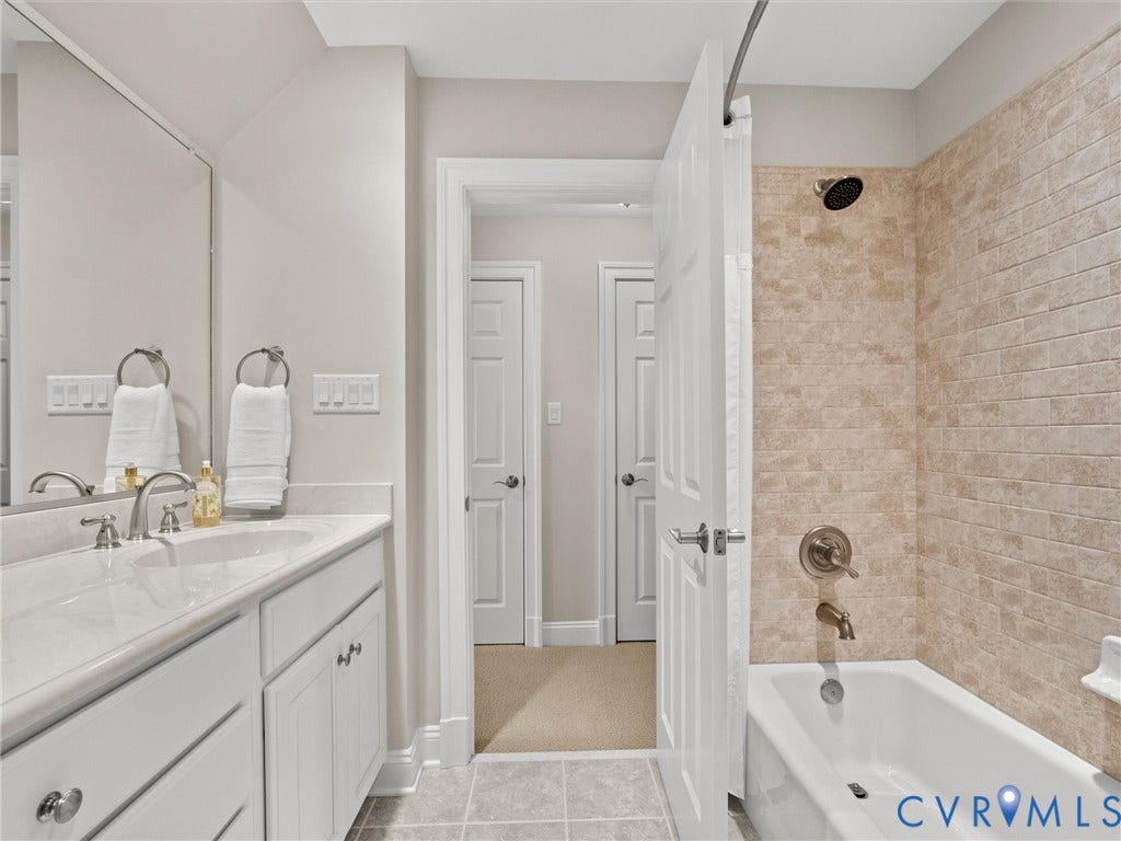 White vanity with dual sinks and chrome fixtures
