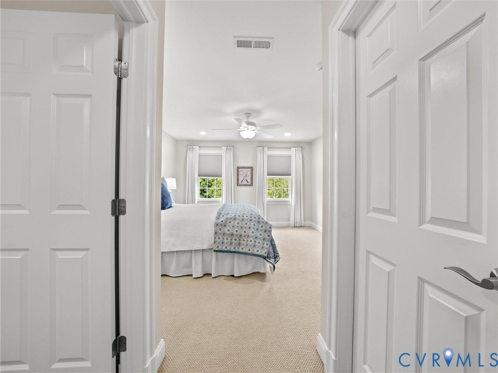 Carpeted room featuring a ceiling fan, recessed lighting, and two windows with blinds