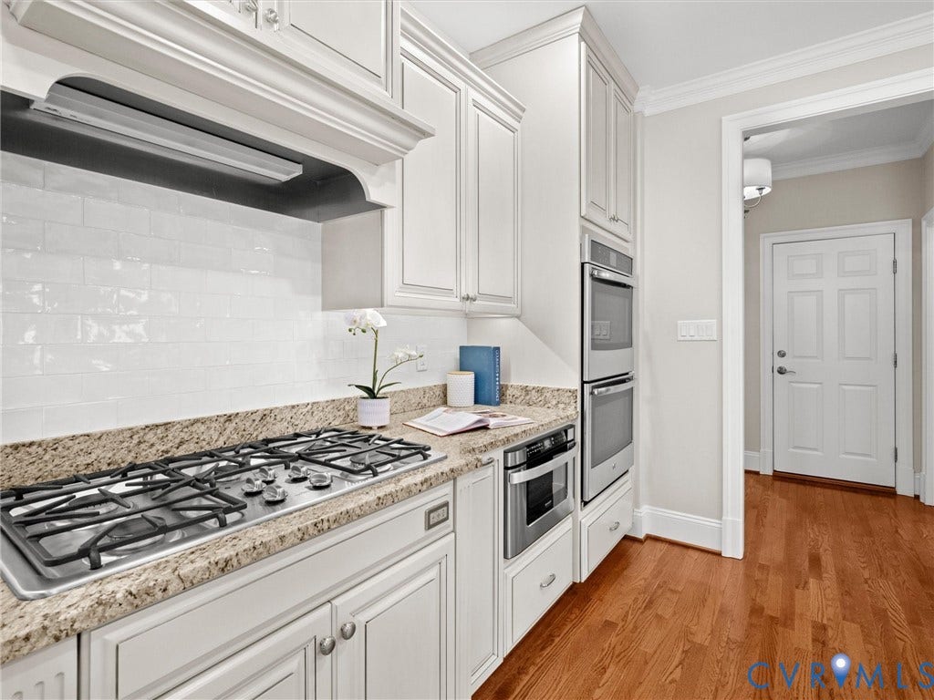 Kitchen featuring white cabinetry, a gas cooktop, double wall ovens, granite countertops, and a white subway tile backsplash
