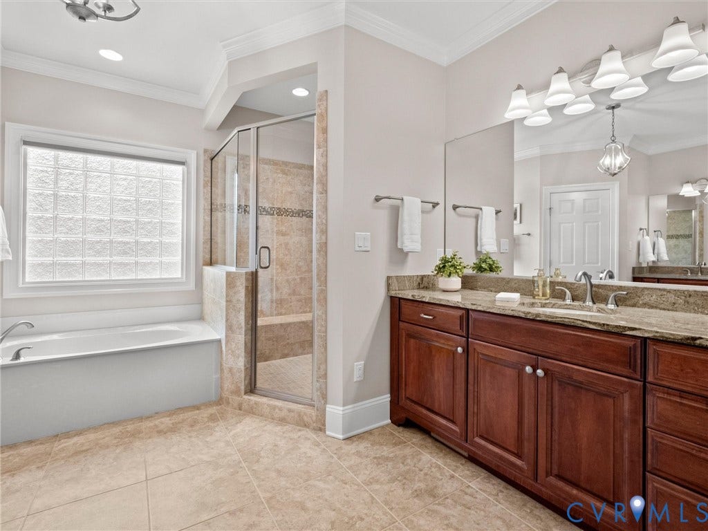 Dual vanity with integrated sinks, granite countertop, and rich wood cabinetry