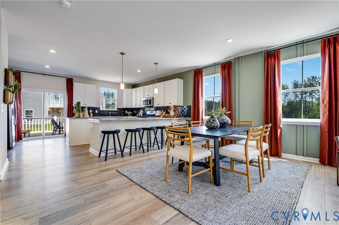 8708 Pullman Lane, Chesterfield, VA 23832 Recessed lighting, wood-finish flooring, white cabinetry, dark stone countertops, and a sliding glass door to an outdoor deck
