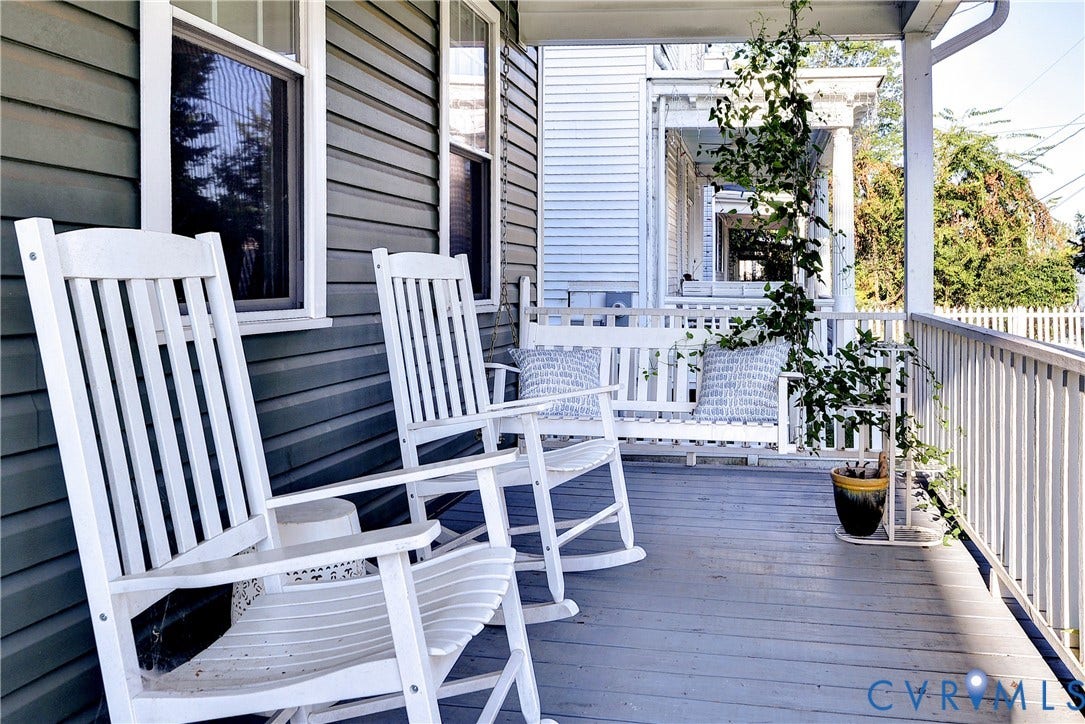 Covered front porch with painted wood flooring and white railing