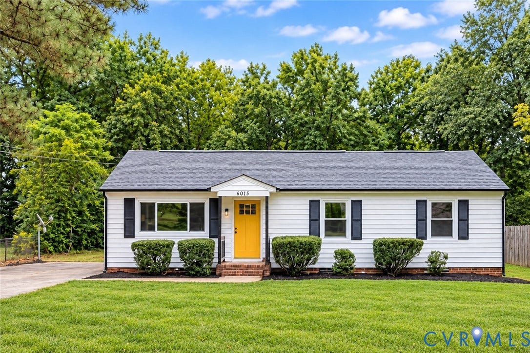 6015 Seaman Road, Westover, Richmond, VA 23225 White siding exterior with a dark shingle roof and a vibrant yellow entry door
