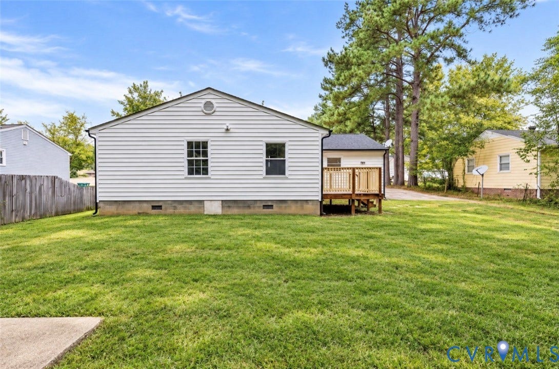 6015 Seaman Road, Westover, Richmond, VA 23225 Expansive lawn with a concrete patio section and a wooden privacy fence