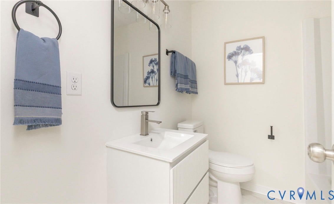 6015 Seaman Road, Westover, Richmond, VA 23225 Vanity with integrated sink, rectangular black-framed mirror, and a modern single-handle faucet