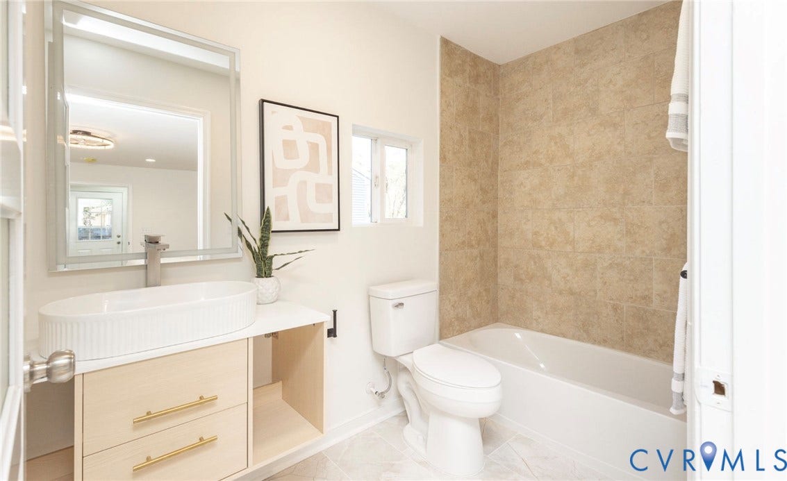 6015 Seaman Road, Westover, Richmond, VA 23225 Contemporary vanity with a vessel sink, a chrome faucet, and gold-finish hardware