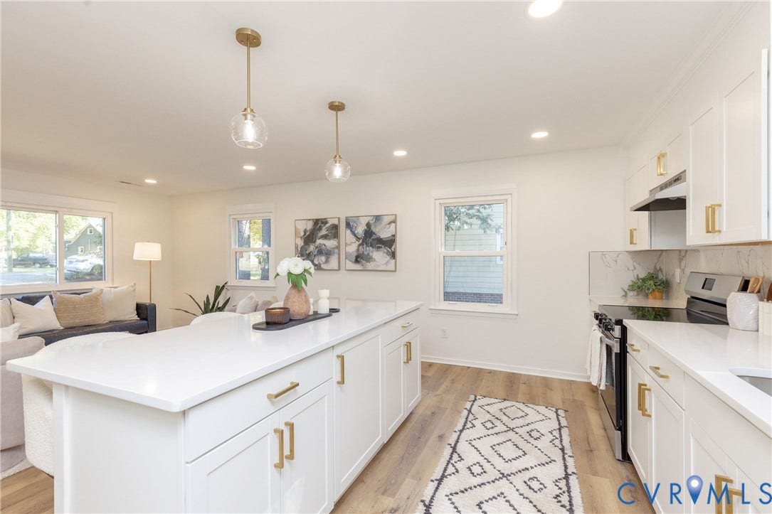6015 Seaman Road, Westover, Richmond, VA 23225 Open concept living space featuring a kitchen island with white cabinetry and gold-tone hardware, recessed lighting, and wood-finish flooring
