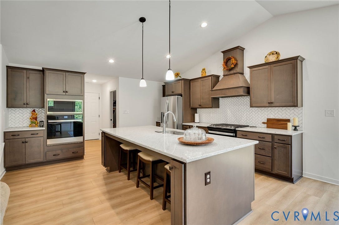 11804 Rydal Way, Cobbs Creek, Glen Allen, VA 23059 Kitchen featuring wood-finish flooring, white countertops, built-in stainless steel appliances, and a central island with pendant lighting