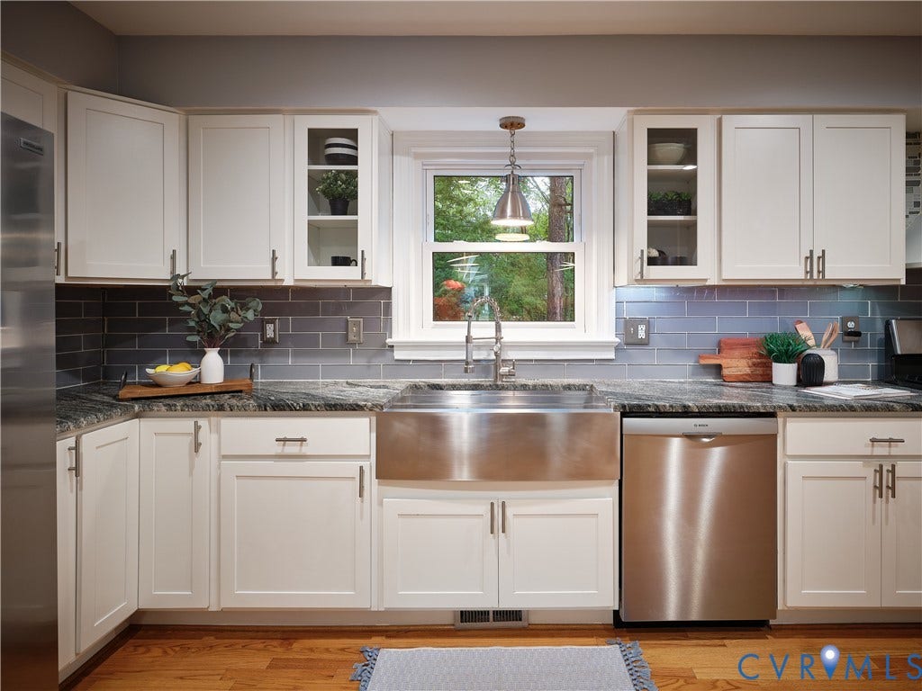 1708 Windingridge Court, Henrico, VA 23238 White shaker-style cabinetry and a beautiful window overlooking the backyard.