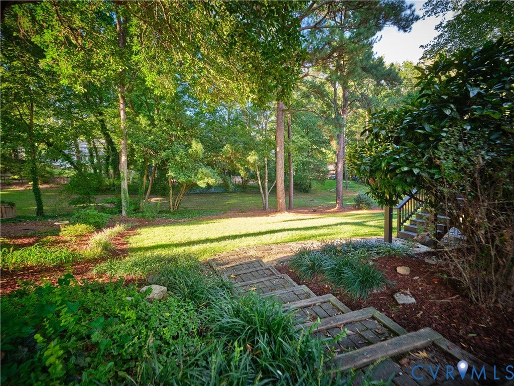 1708 Windingridge Court, Henrico, VA 23238 Expansive outdoor space featuring a manicured lawn, mature trees, and natural landscaping