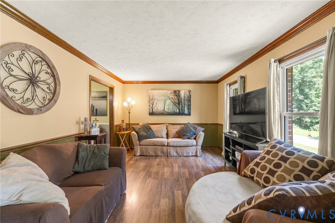 Wood-finish flooring throughout, complemented by crown molding and chair rail detailing