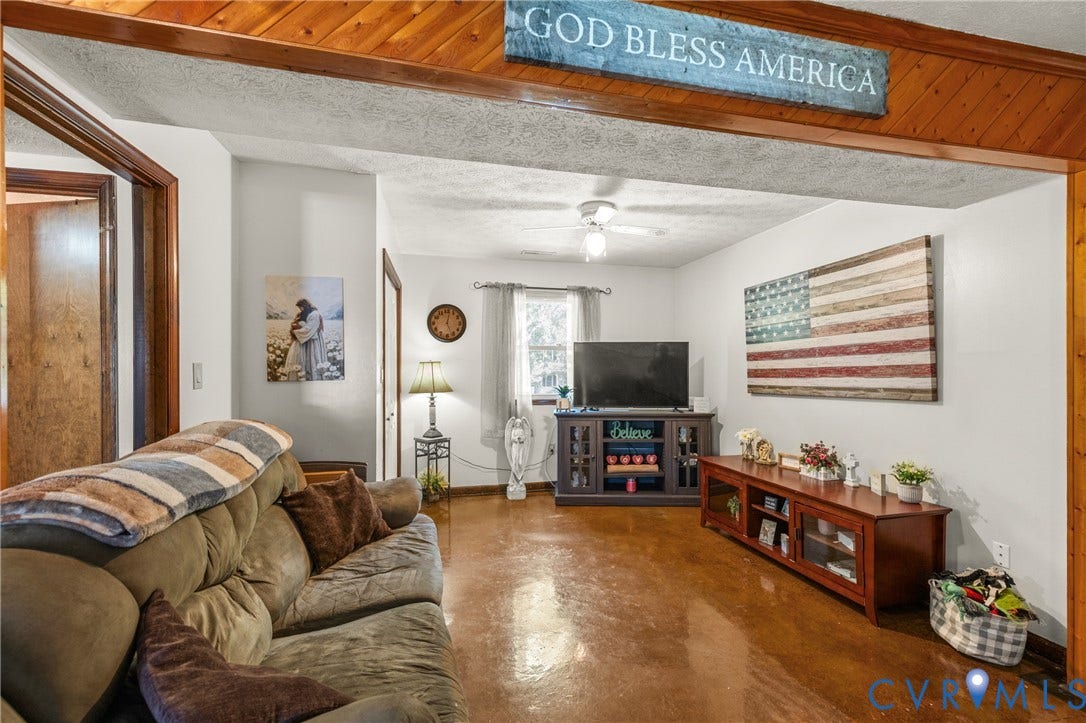 Wood-finish ceiling beams, wood-finish flooring, and white painted walls