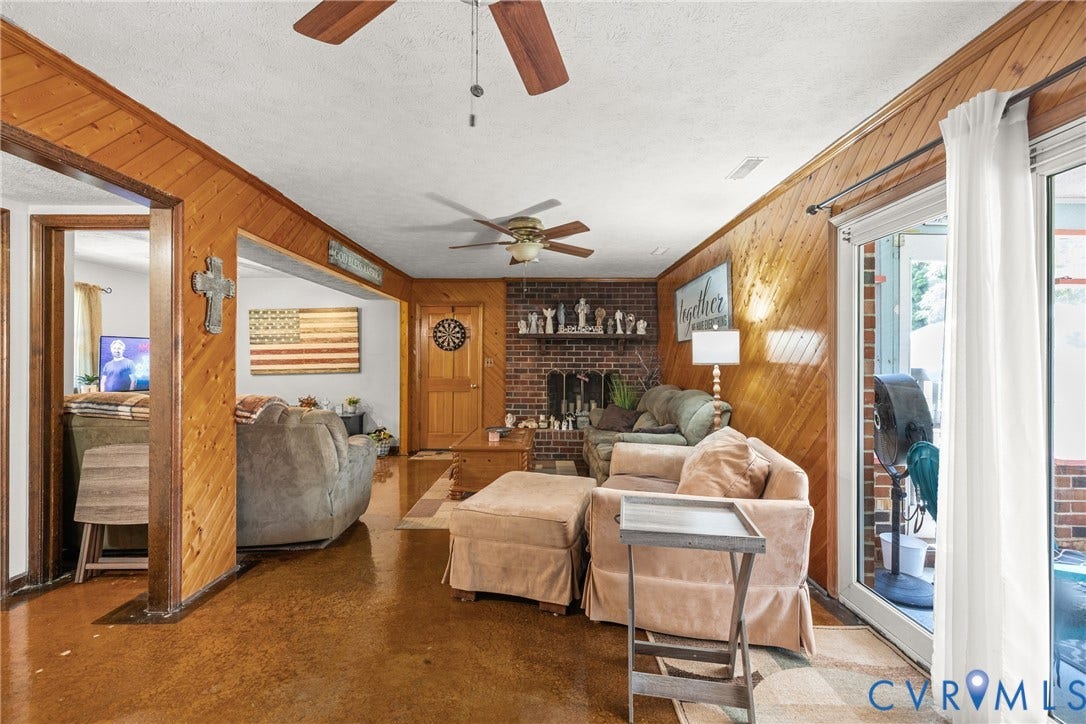 Wood-paneled walls and a brick fireplace