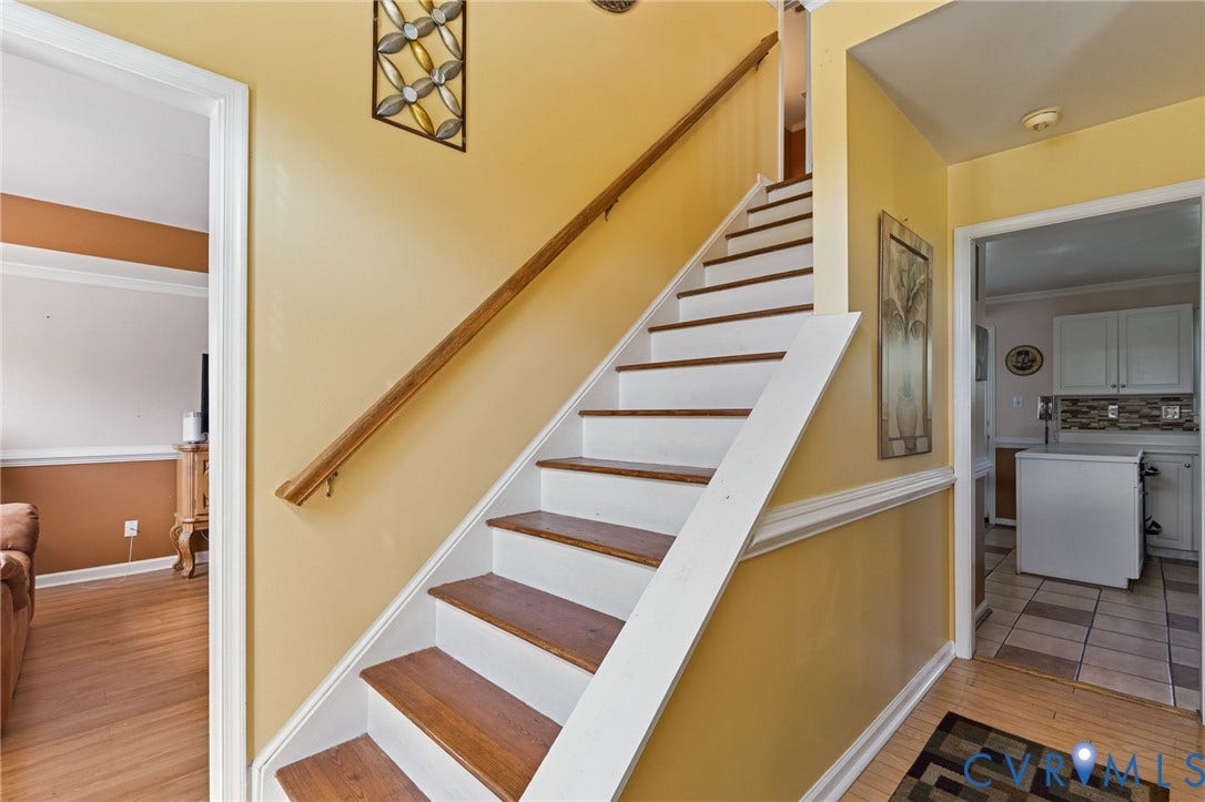 14119 Kentwood Forest Drive, Kentwood Forest, Chester, VA 23831 Staircase with wood-finish treads and white risers, featuring a wood handrail