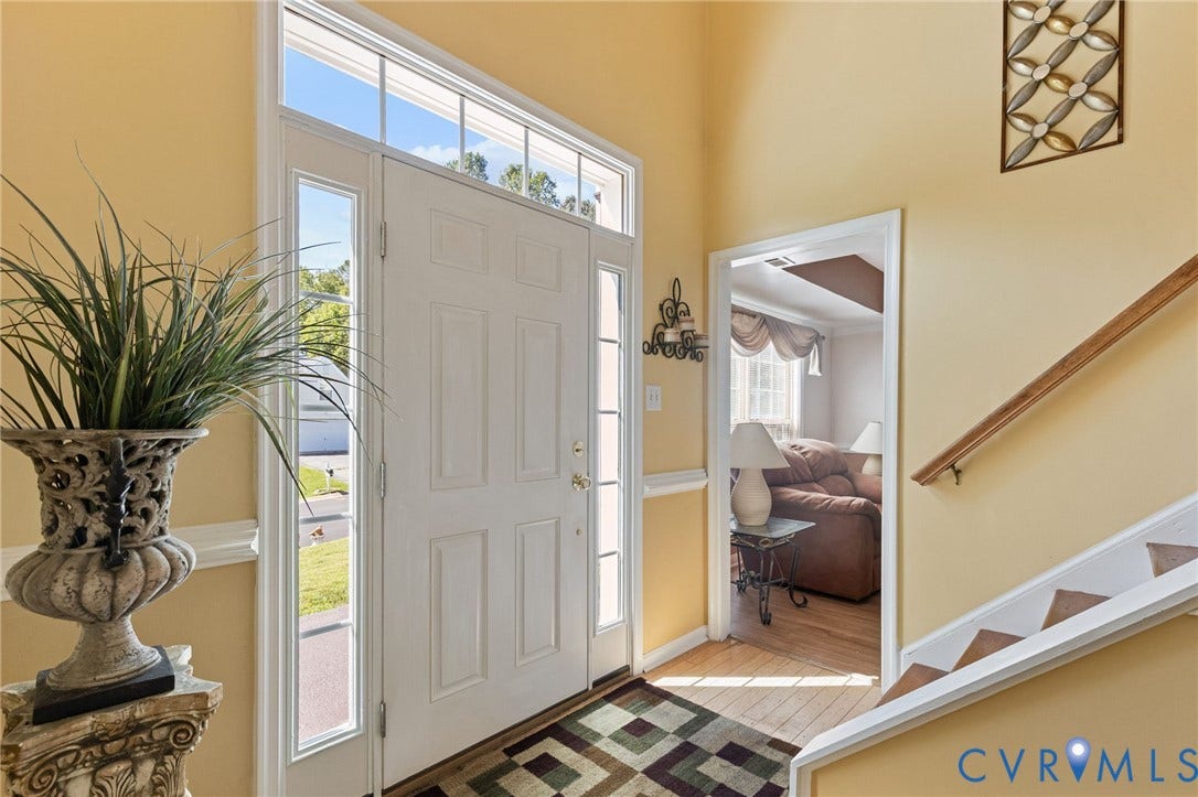 14119 Kentwood Forest Drive, Kentwood Forest, Chester, VA 23831 Paneled entry door with sidelights and transom window, hardwood flooring, and a built-in staircase