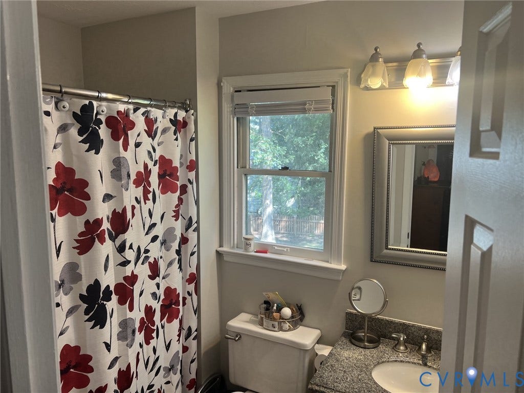 8336 Devils Den Lane, Mechanicsville, VA 23111 Bathroom featuring a window, granite-finish countertop, and wall-mounted vanity light fixture