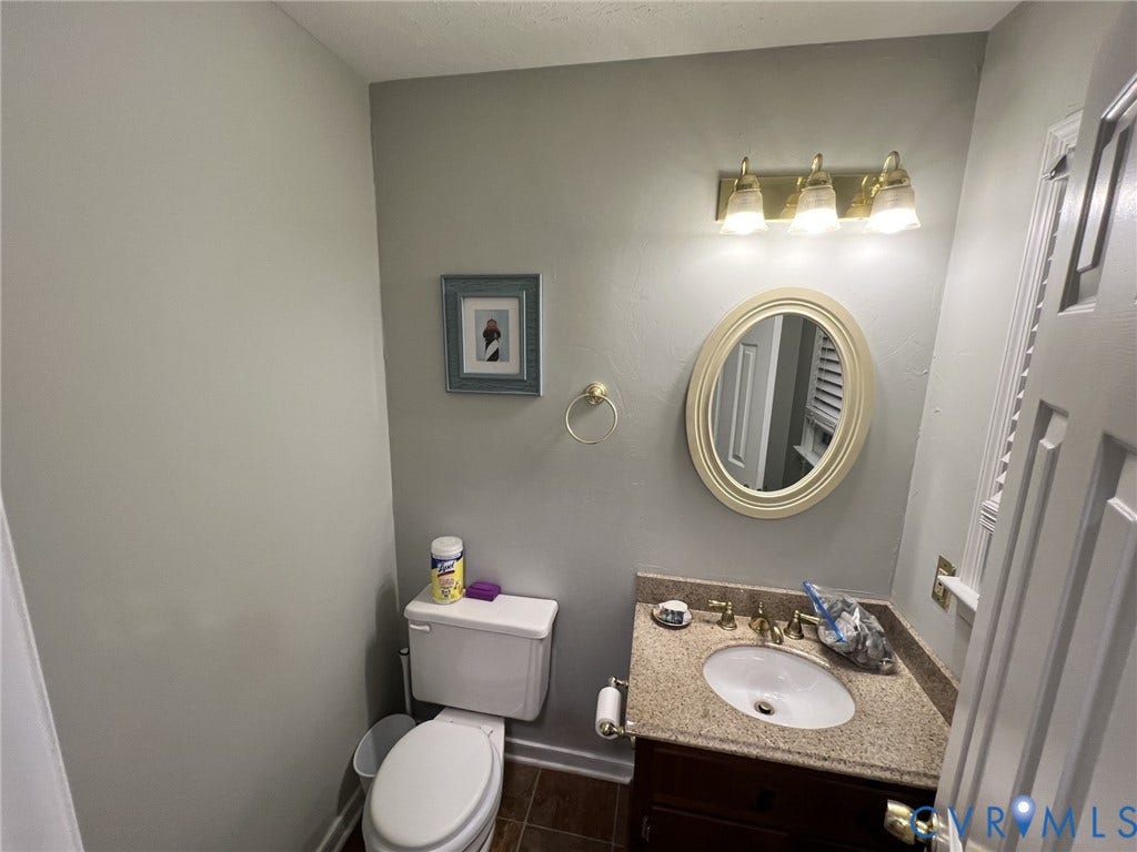 8336 Devils Den Lane, Mechanicsville, VA 23111 Vanity with a granite-style countertop, undermount sink, and brass-finish faucet