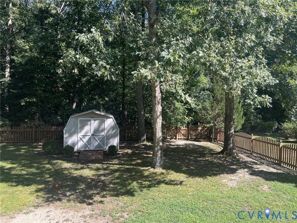 8336 Devils Den Lane, Mechanicsville, VA 23111 White storage shed with a gambrel roof and double doors