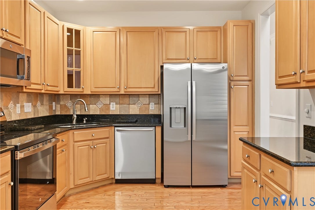 Kitchen Featuring Granite Countertops and Custom Tile Backsplash.
