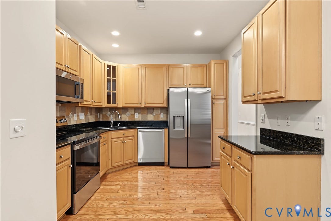 Kitchen Featuring Engineered HW Floors and Stainless-Steel Appliances.