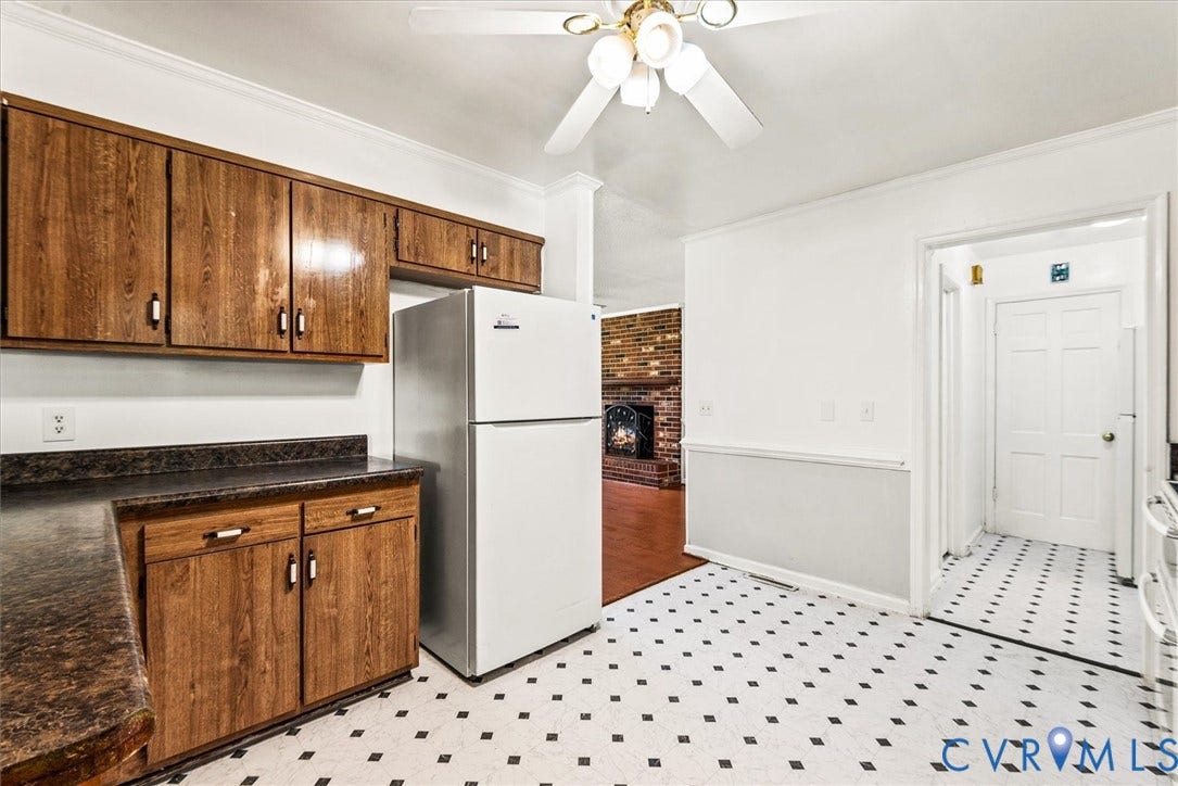 13012 Harrowgate Road, Chesterfield, VA 23831 Kitchen featuring wood-finish cabinetry, solid surface countertops, a ceiling fan, and black and white patterned flooring