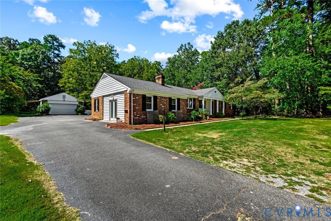 13012 Harrowgate Road, Chesterfield, VA 23831 Brick and siding exterior with a covered entry, established landscaping, and a detached two-car garage