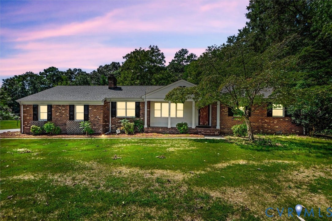 13012 Harrowgate Road, Chesterfield, VA 23831 Brick exterior with a dark-pitched roof, framed by mature trees, and a covered entry with white columns