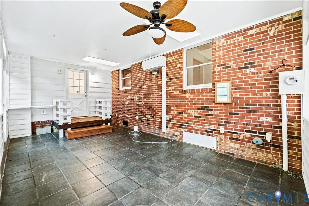 13012 Harrowgate Road, Chesterfield, VA 23831 Tiled flooring with brick and white shiplap walls, featuring a skylight and ceiling fan
