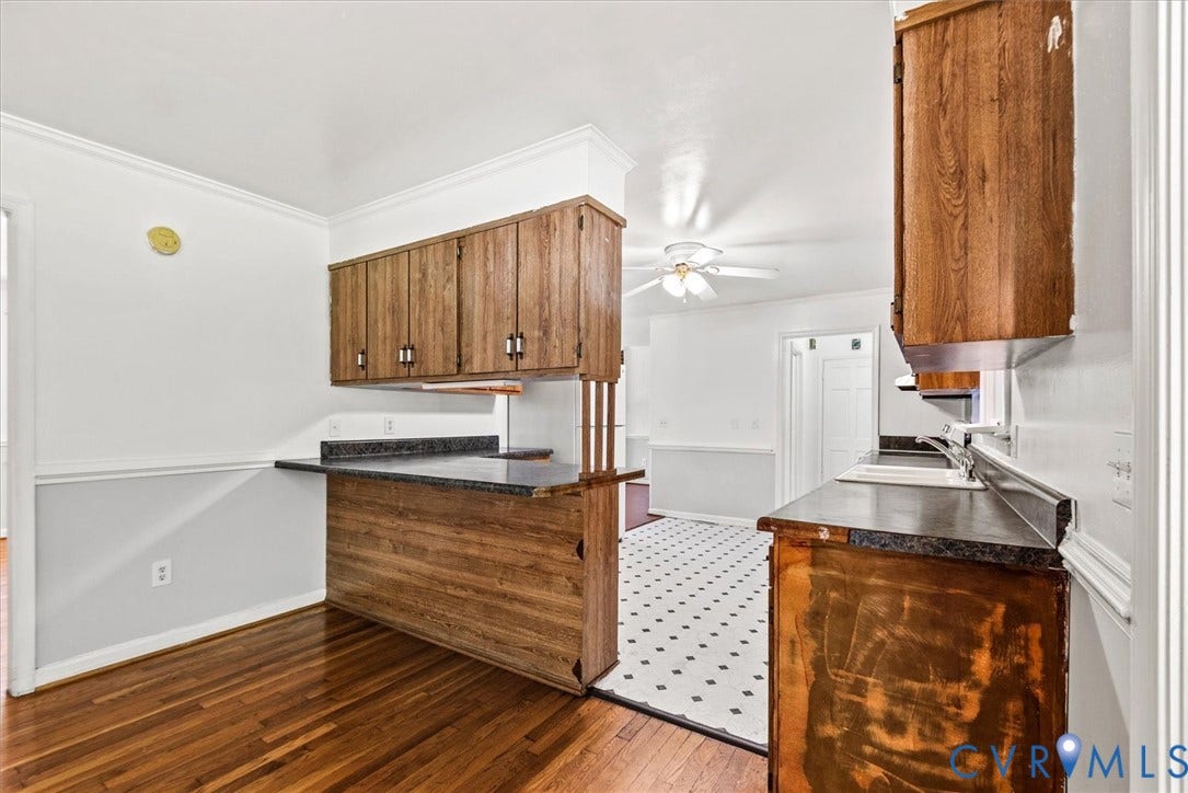 13012 Harrowgate Road, Chesterfield, VA 23831 Wood-finish cabinetry with dark countertops, wood-finish flooring, and crown molding