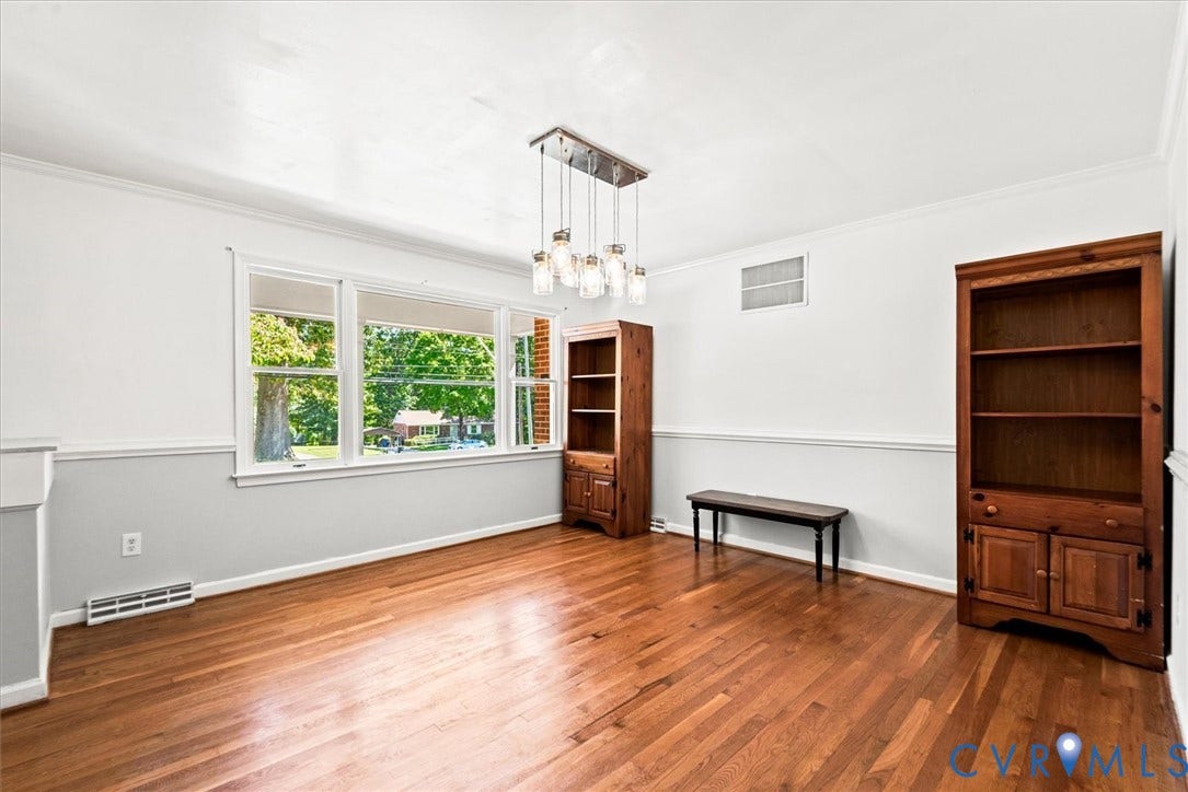 13012 Harrowgate Road, Chesterfield, VA 23831 Hardwood flooring, painted walls with wainscoting, multi-pane window, and a multi-bulb chandelier