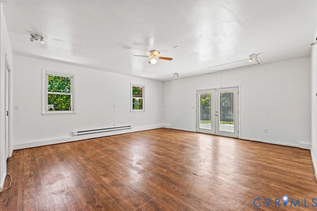 13012 Harrowgate Road, Chesterfield, VA 23831 Expansive room with wood-finish flooring, white walls, and track lighting
