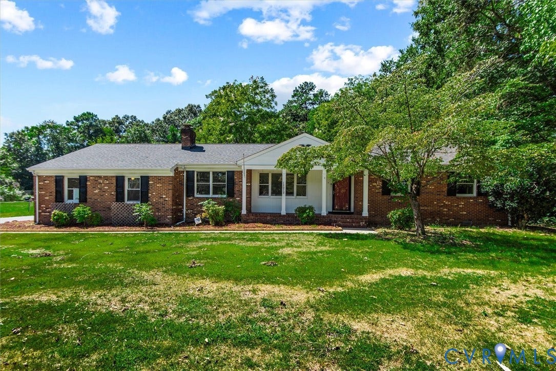 13012 Harrowgate Road, Chesterfield, VA 23831 Brick exterior with black shutters, a covered entry, white columns, and a dark shingle roof