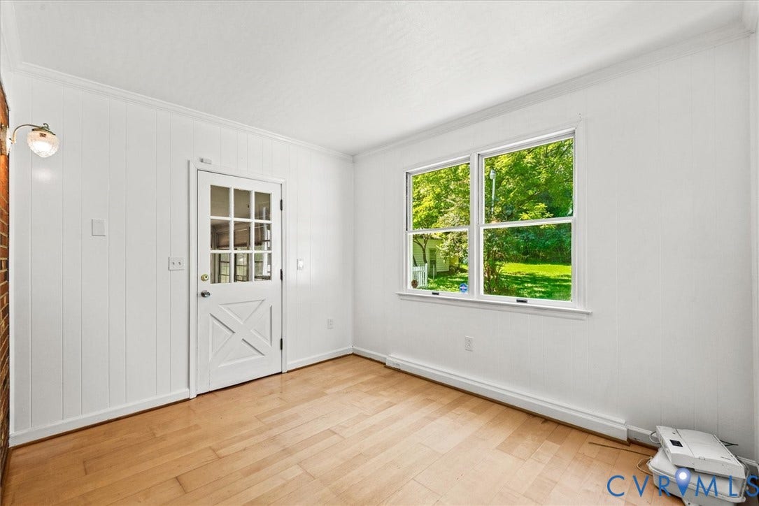 13012 Harrowgate Road, Chesterfield, VA 23831 Light wood-finish flooring, white paneling, white crown molding, and a white interior door with glass panes