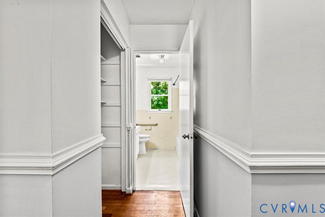 13012 Harrowgate Road, Chesterfield, VA 23831 Hallway featuring wainscoting with decorative trim and wood-finish flooring