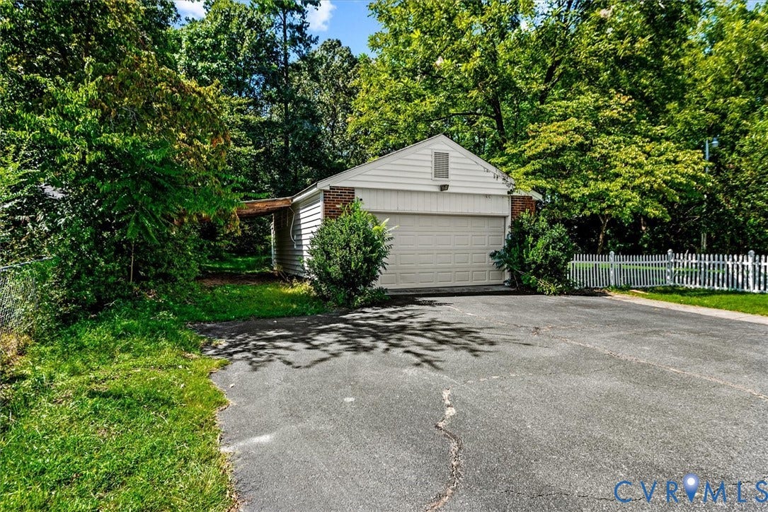 13012 Harrowgate Road, Chesterfield, VA 23831 Detached garage with a single overhead door, brick accents, and white siding